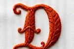 Example of an intricate, decorative calligraphic font for the initial 'D' in embroidery.